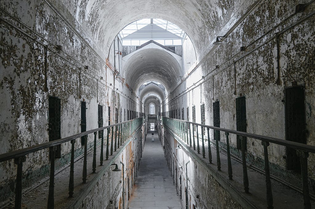 A bleak and rundown cell block of Eastern State Penitentiary