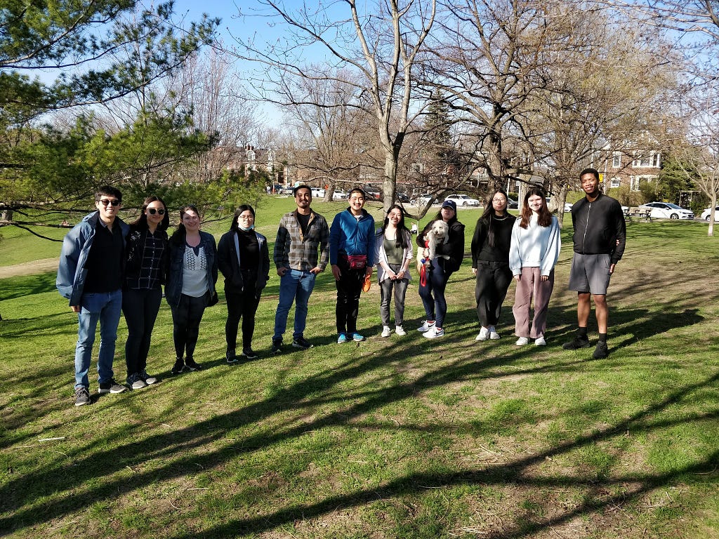 Volunteers posing for a group photo at a park