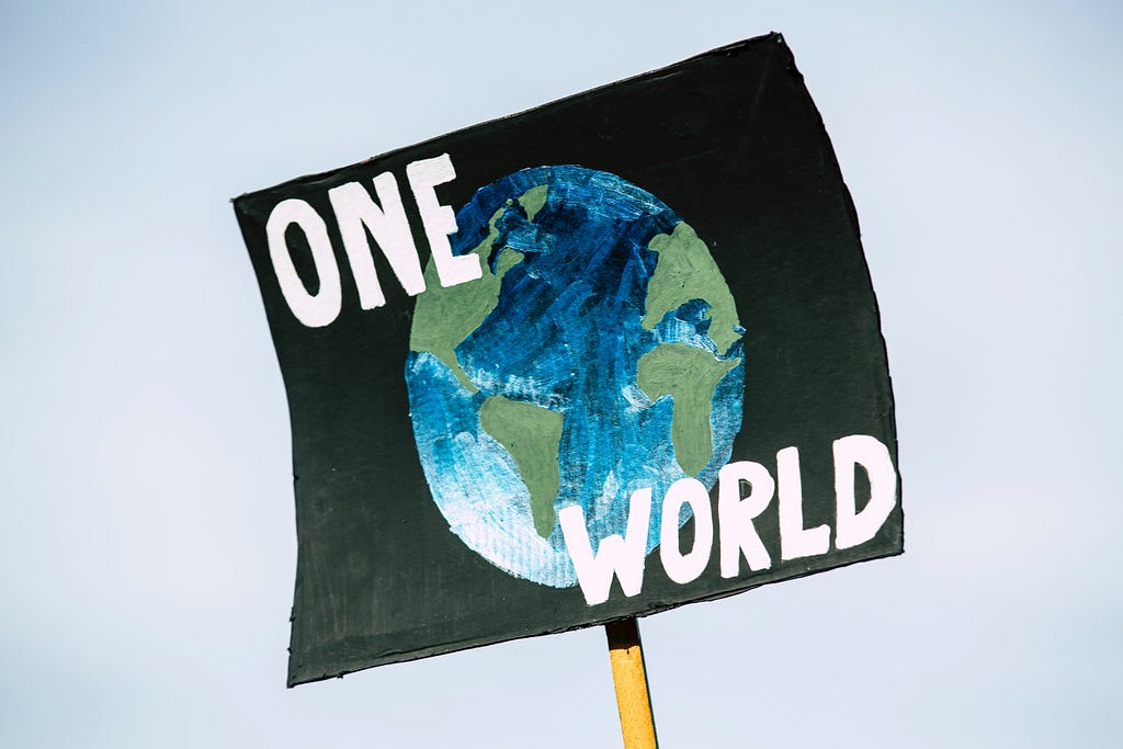 Protest sign saying ‘One world’
