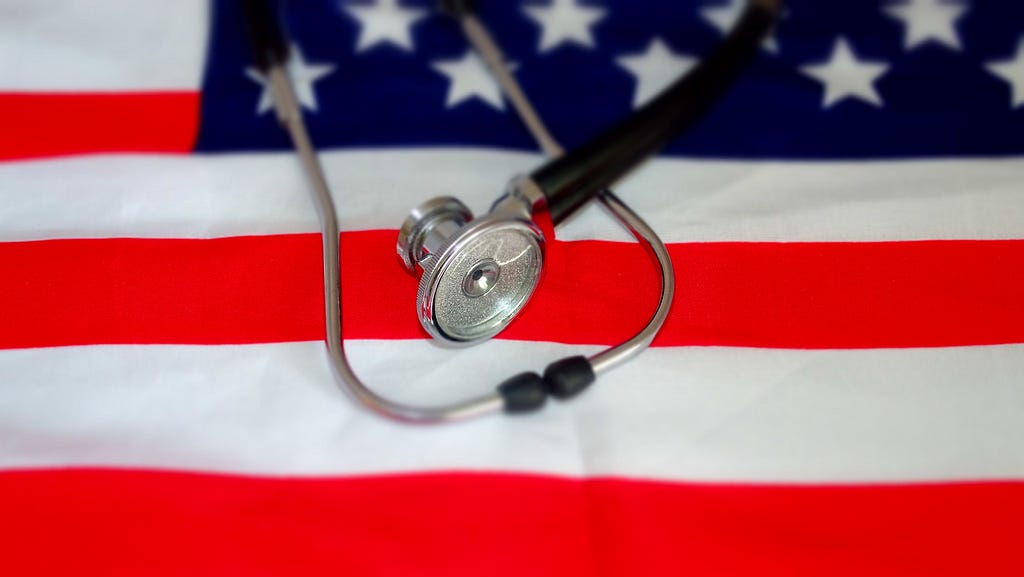 A stethoscope lying on an American flag.