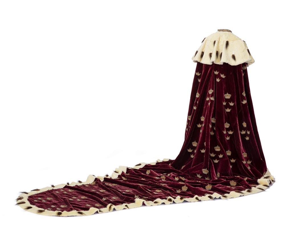 A royal coronation mantel/cloak, red with guilded embroderie.