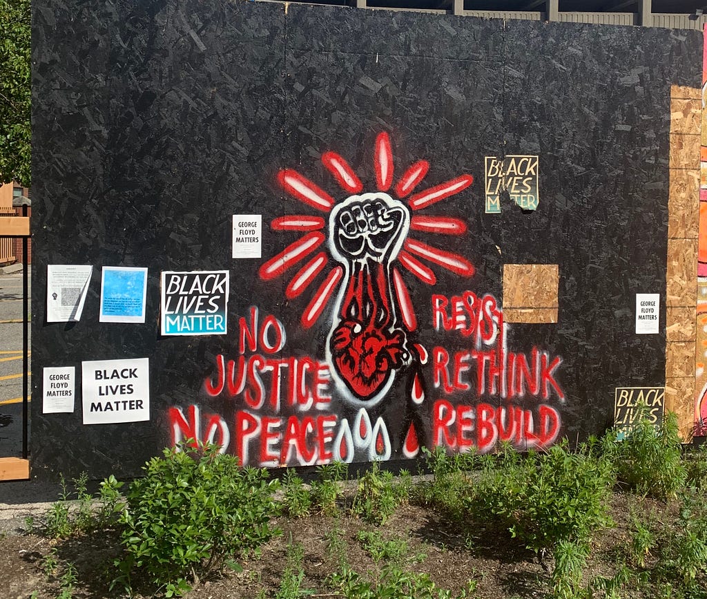 No Justice, No Peace mural — red fist and heart on black background