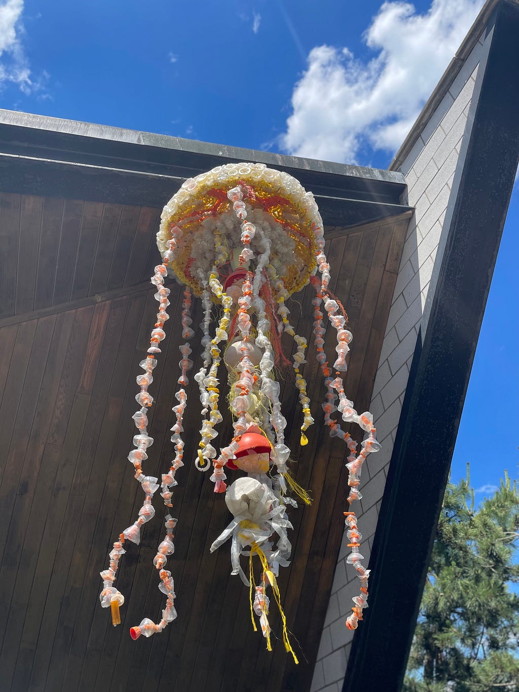 A jellyfish made of recycled ocean plastic hangs at the New York Aquarium