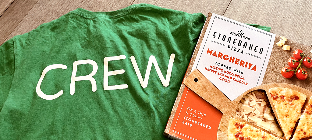 Green NUX t-shirt with the word crew printed on the back. Accompanied with a stonebaked Margherita pizza.