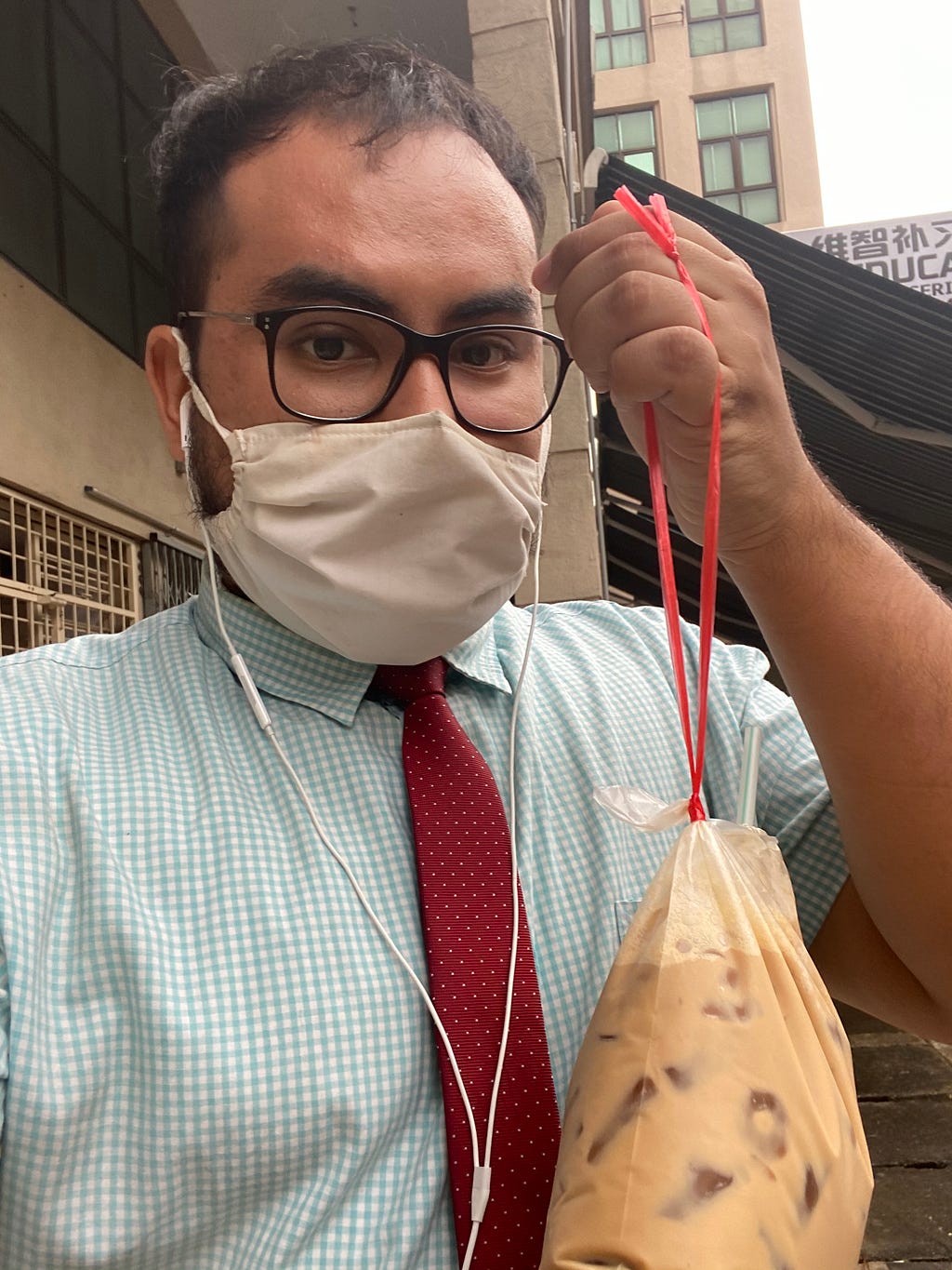 Picture of author holding a bag of iced coffee