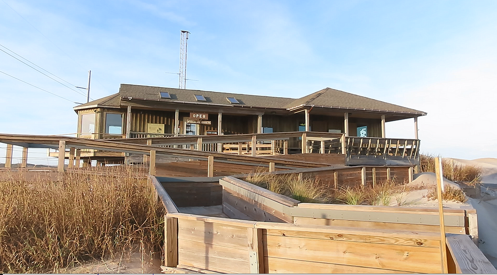 building on beach with back -and-forth wooden ramp