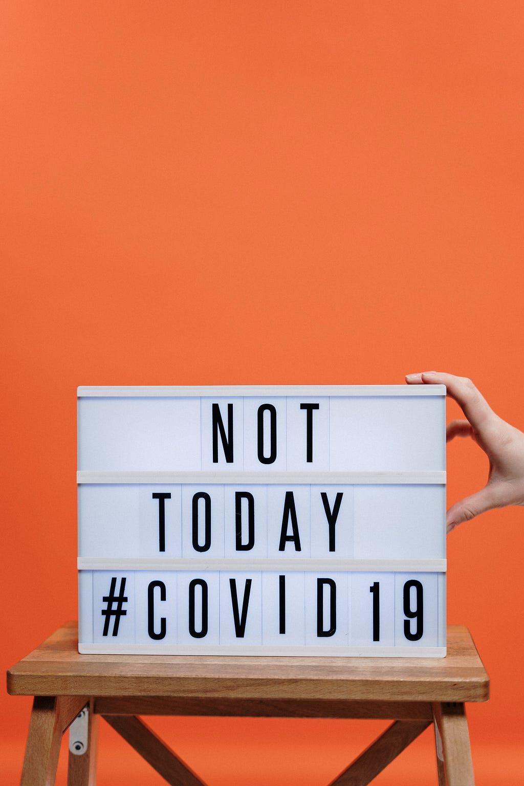 Not today COVID 19 sign on a wooden stool