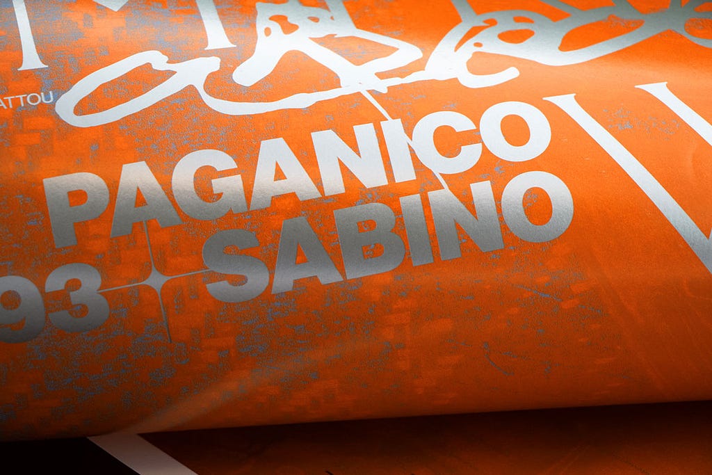 Close-up shoot of printed orange poster for Lito Kattou solo show