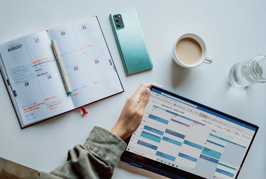 Cover image. A person checking a calendar on a tablet device.