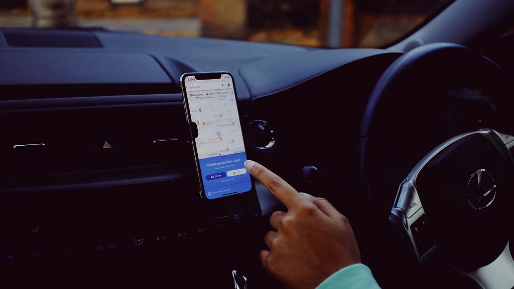 Image of a smartphone in a phone holder in a car.