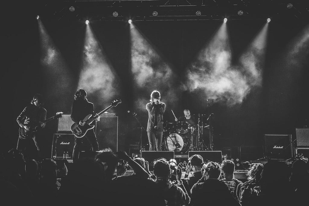 black and white photo of rock band on music festival