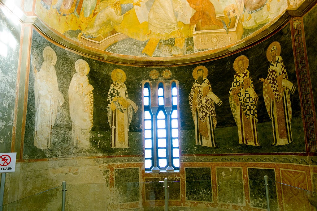 a wall covered in mosiac tiles depicting 6 holy figures