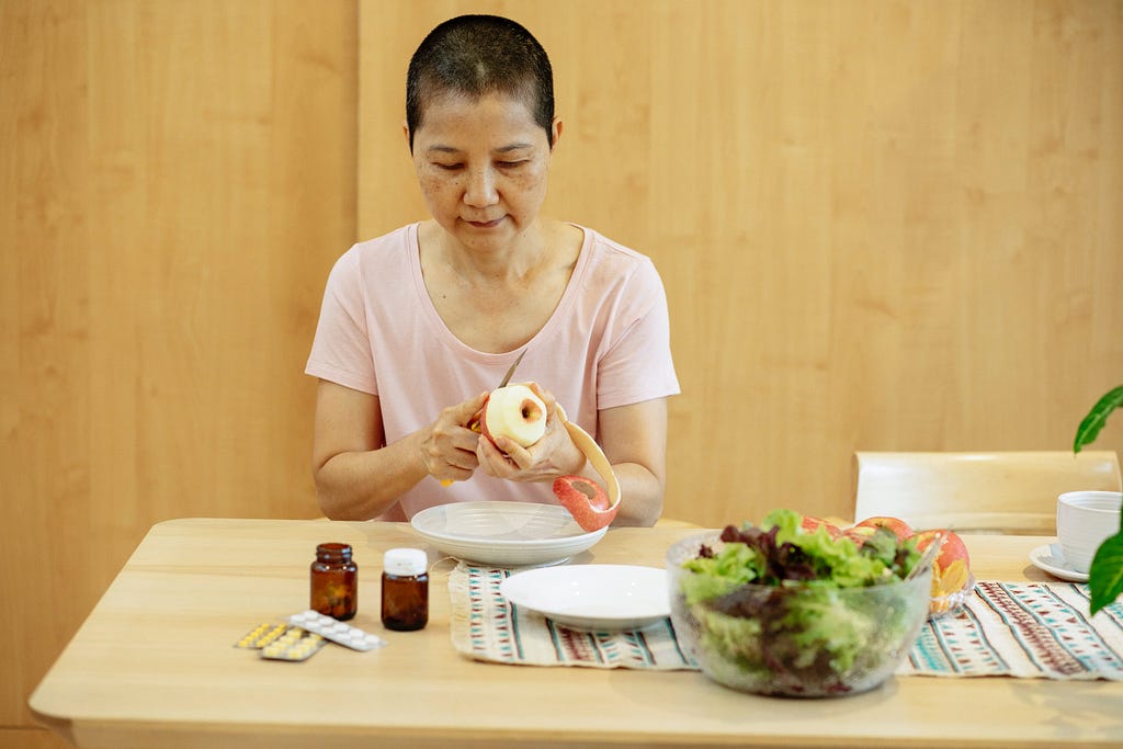 Cancer survivor peeling an apple