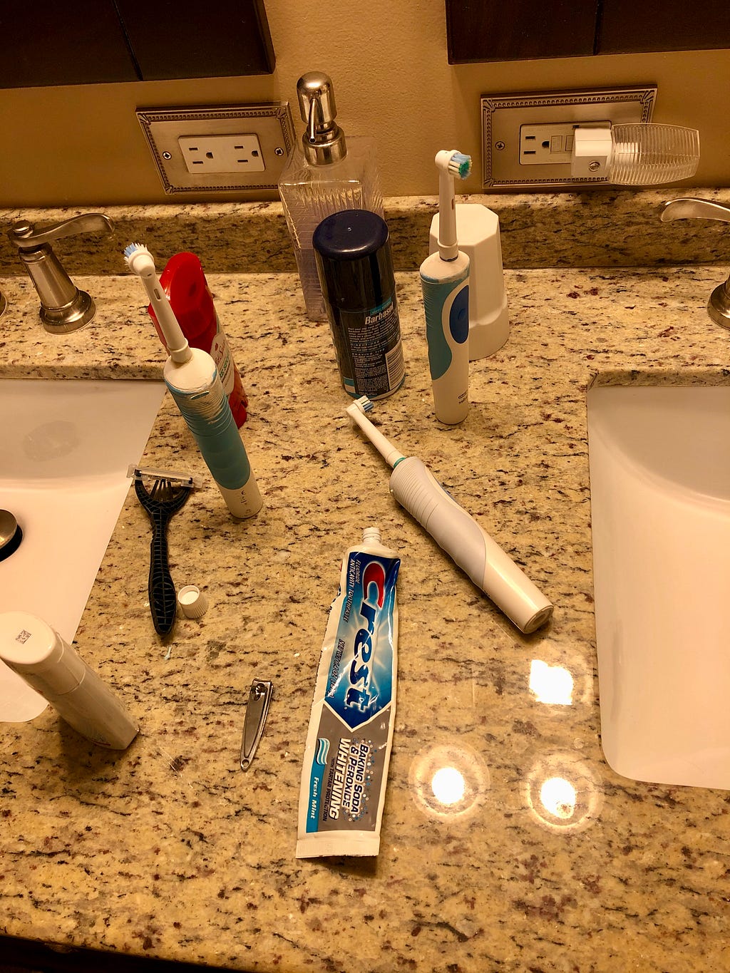 Author’s photo of her bathroom counter with toothbrushes, a toothpaste tube with the cap off, deodorant.