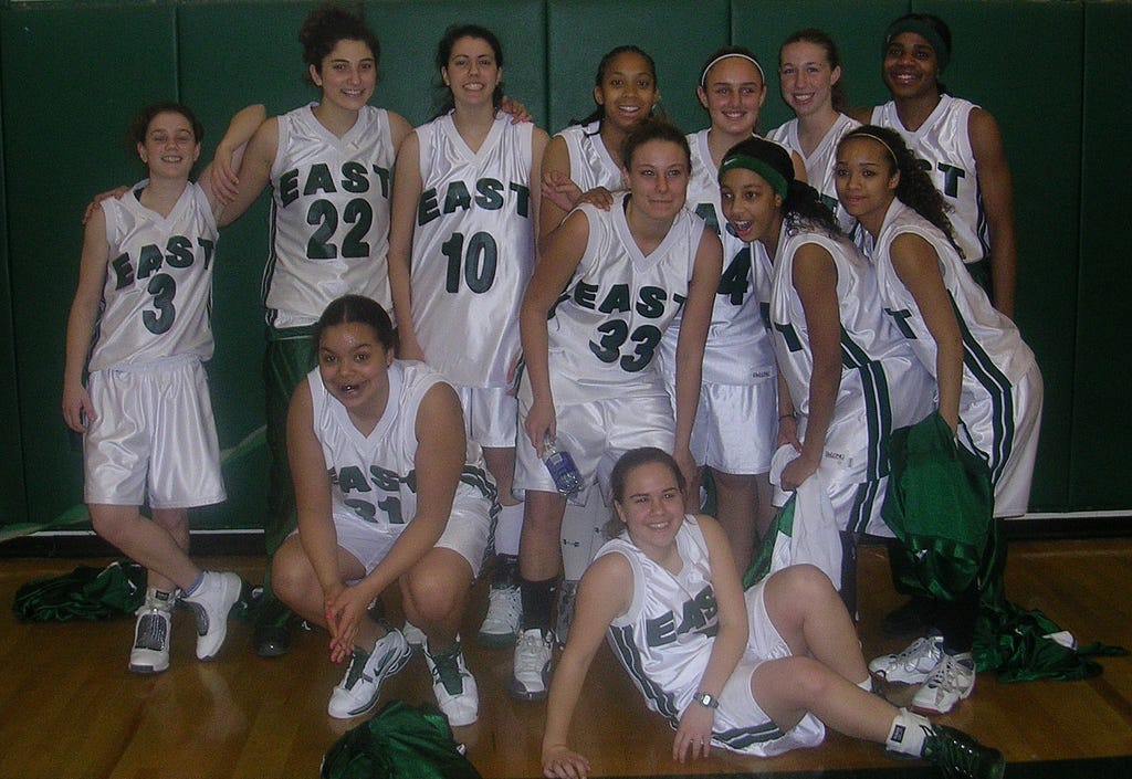 A group of high school basketball players posing for an informal team photo