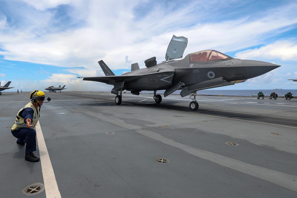 An F-35B fast jet takes off from the flight deck of HMS Queen Elizabeth.