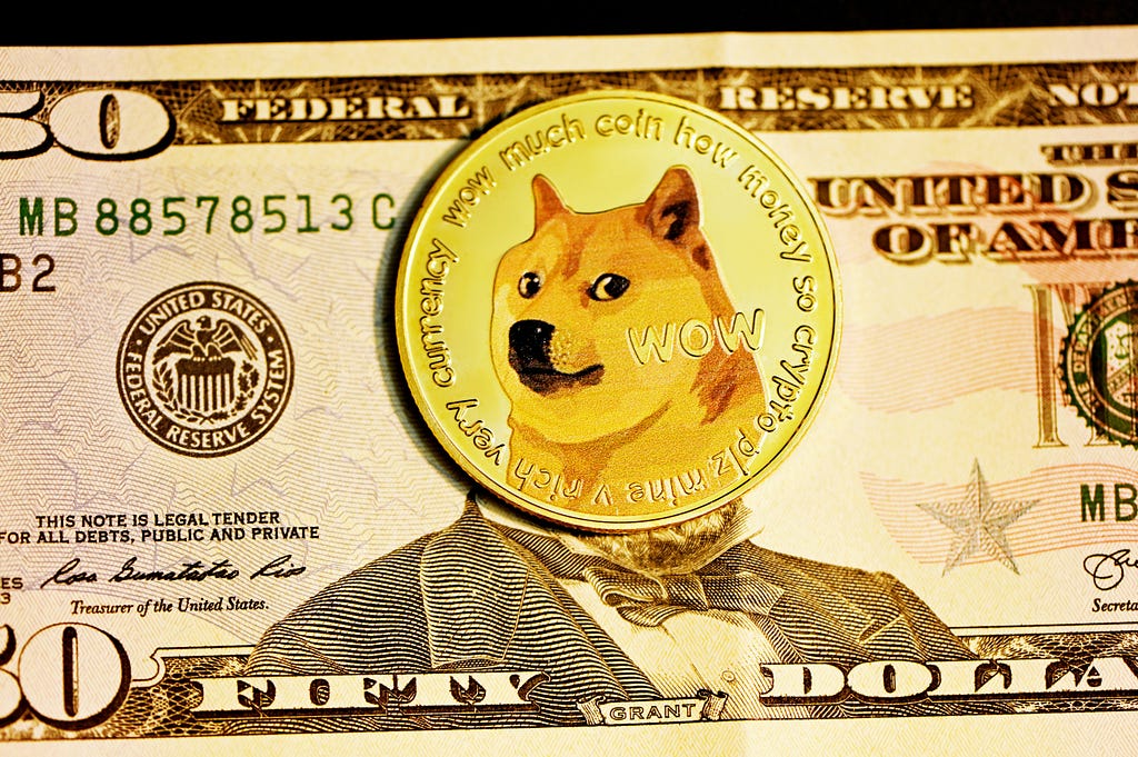 A physical Doge coin on top of a $50 bill, covering Ulysses S. Grant’s face.