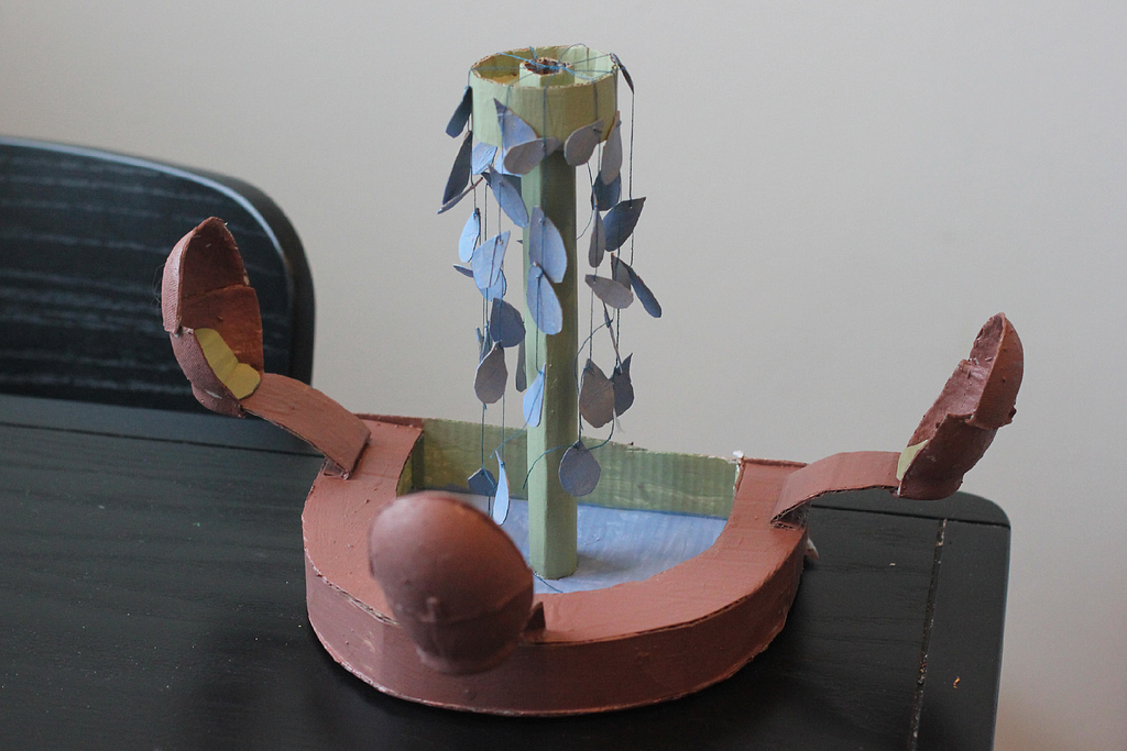 An image of a paper constructed fountain with sitting places around it.