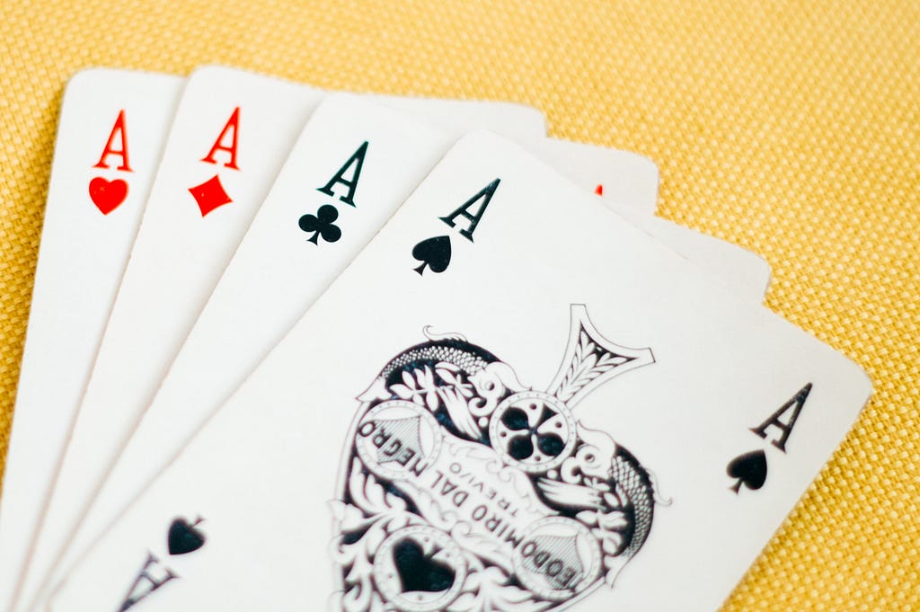 Four aces in a hand of playing cards.
