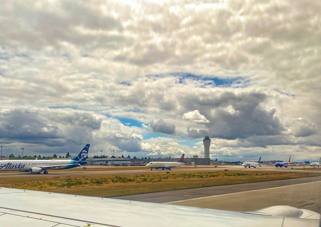 Planes lined up on the runway at Seattle-Tacoma Airport.