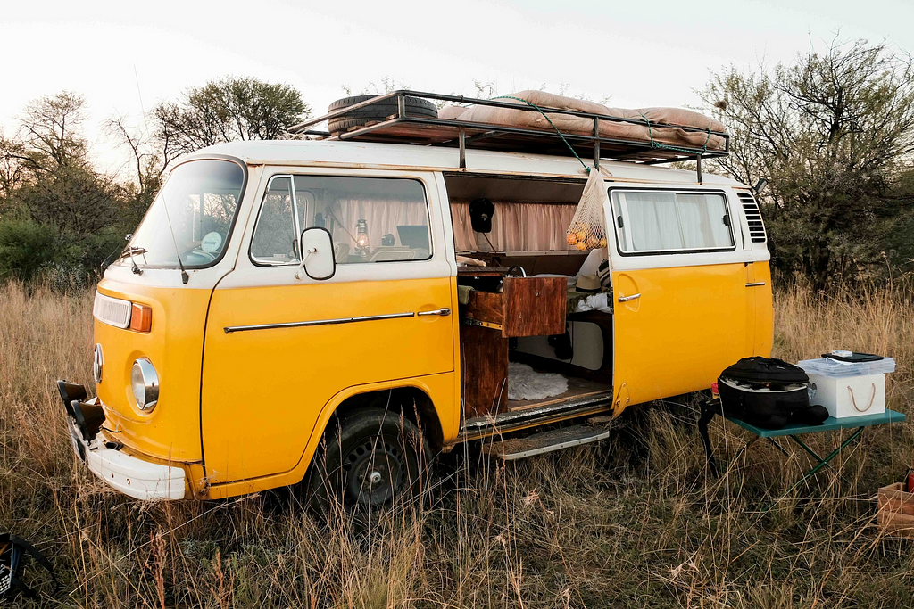 VW classic micro camper with side door open revealing interior