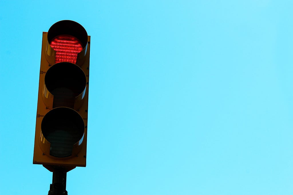 A traffic light with the blue sky in the background