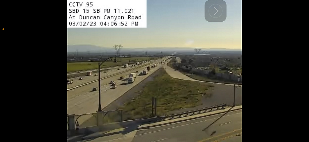traffic cam footage of I-15 southbound and an overpass at the bottom of the photo.