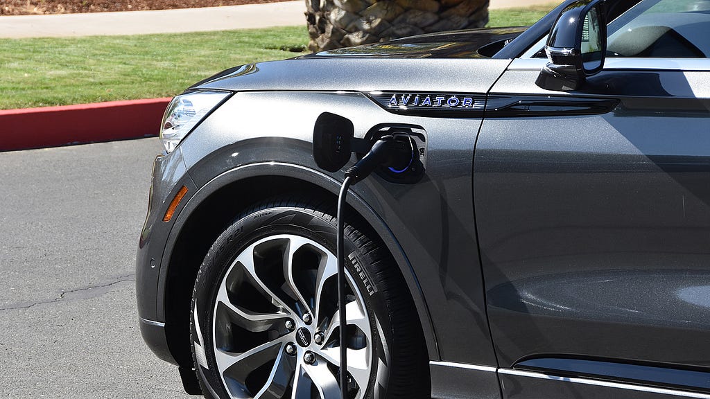 A 2020 Lincoln Aviator Grand Touring is plugged in and charging.
