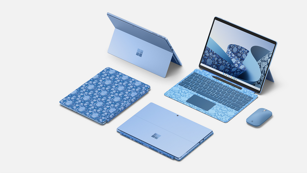 An image of four blue engraved and printed laptops in different states