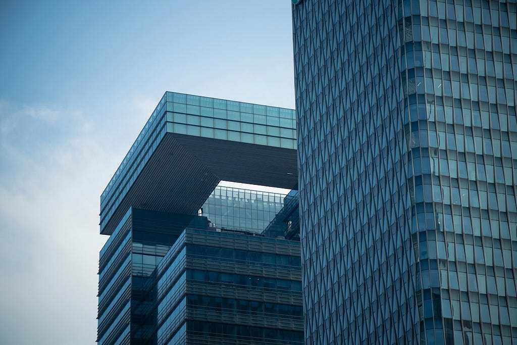 Two skyscrapers against a blue sky.