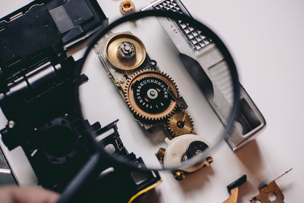 A magnifying glass looking at mechanical parts