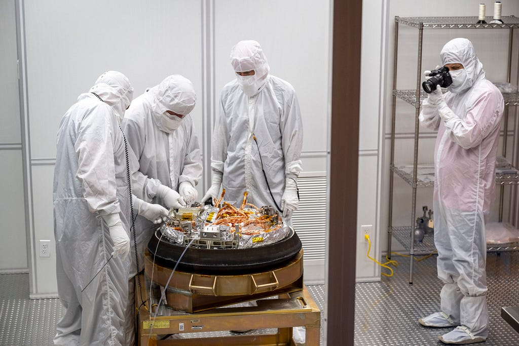 Curation teams process the sample return capsule from NASA’s OSIRIS-REx mission in a cleanroom, Sunday, Sept. 24, 2023, at the Department of Defense’s Utah Test and Training Range. The sample was collected from the asteroid Bennu in October 2020 by NASA’s OSIRIS-REx spacecraft. Photo Credit: (NASA/Keegan Barber)