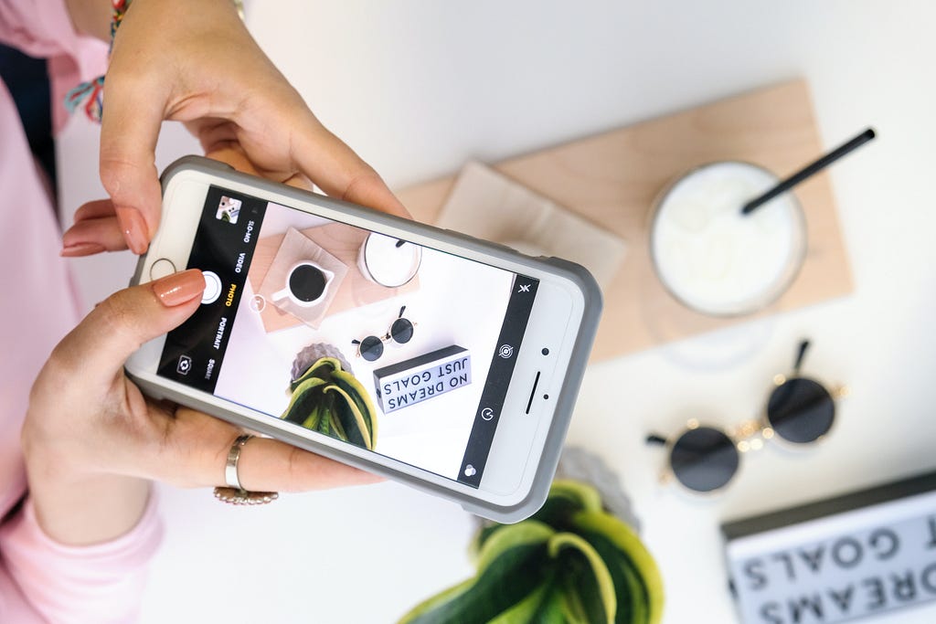 Figure 1. Person Taking Photo of Milk and Coffee. Photo by The Lazy Artist Gallery from Pexels