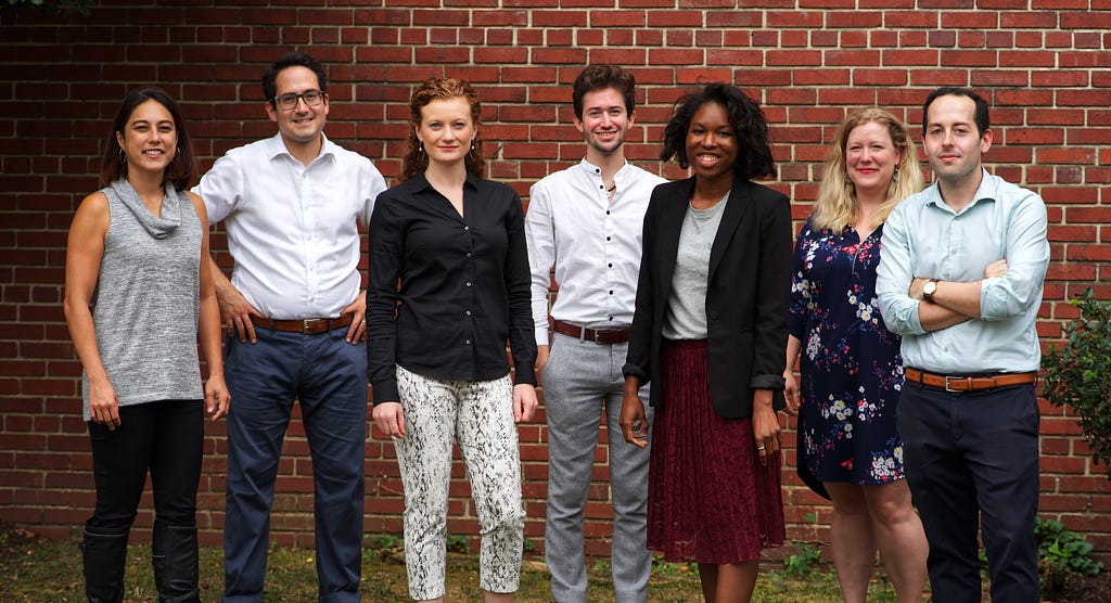 Seven Center on Privacy & Technology staff members stand in front of a brick wall.