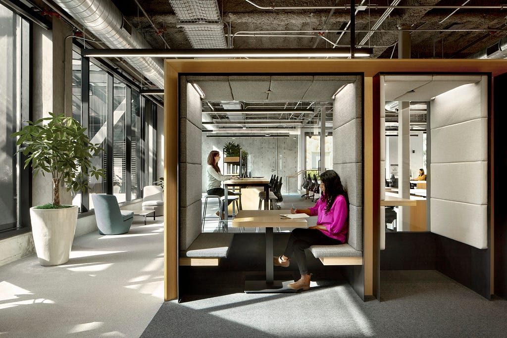 Semi-private spaces are interspersed within work areas.