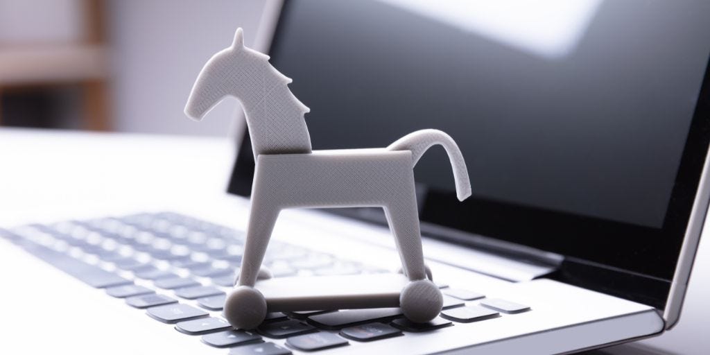 toy horse on computer keyboard