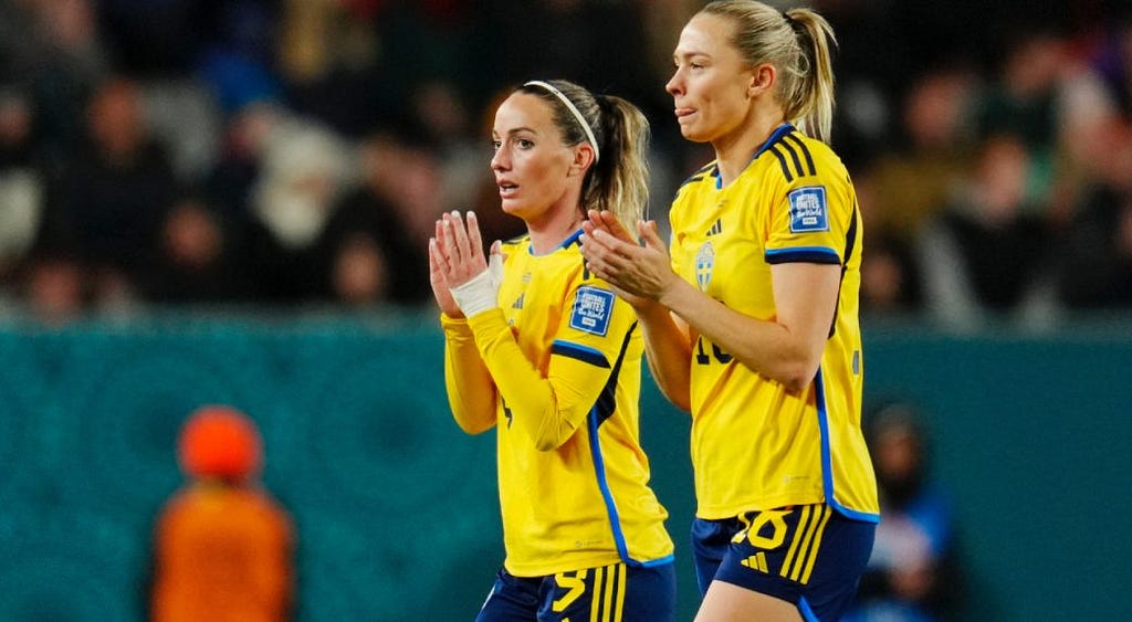 photo of sad Sweden players clapping supporters