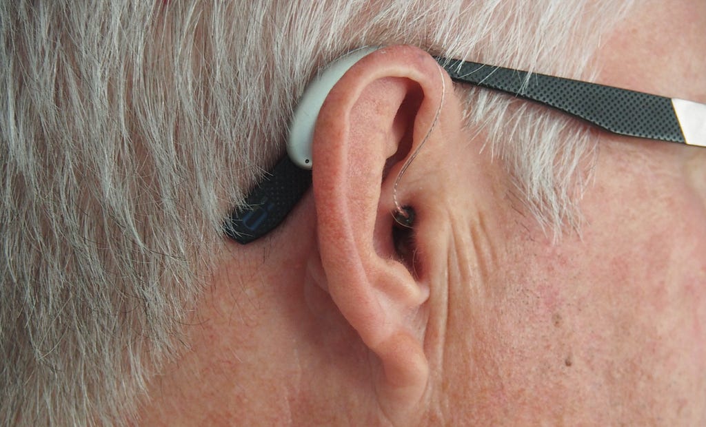 Close up of a person wearing a hearing aid