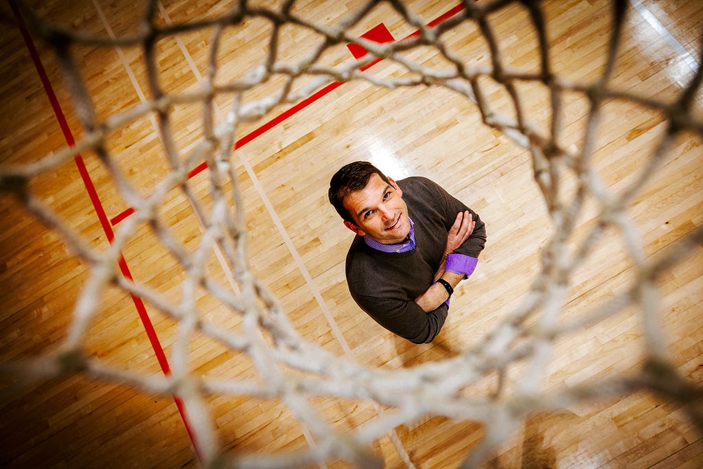 Zac looks up through the net of a basketball hoop