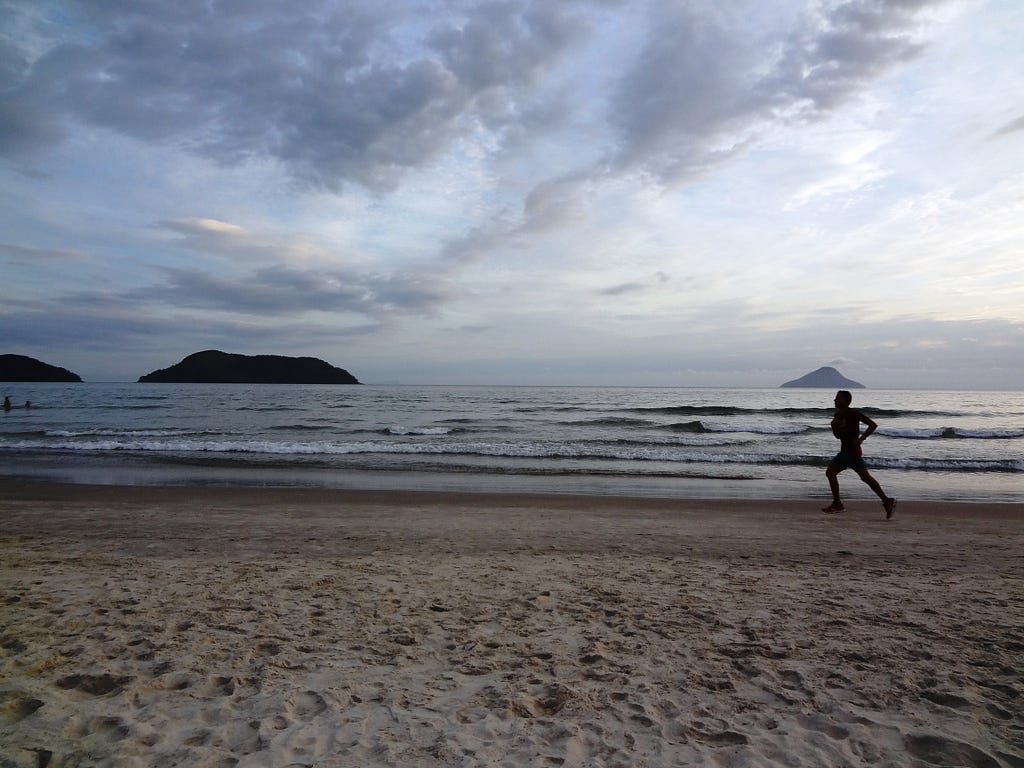 Silhouette of man running on beach