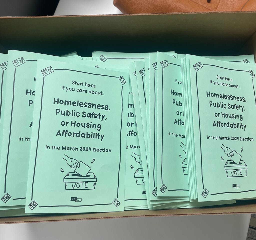 A blue half-folded paper with text that reads “Start here if you care about… homelessness, public safety, or housing affordability in the March 2024 election.”