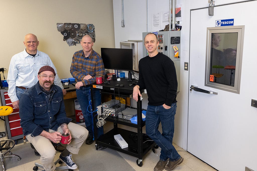 Robert “Trey” Coker, Brent Ruby, Dustin Slivka and Walter Hailes are pictured near their lab’s environmental chamber.