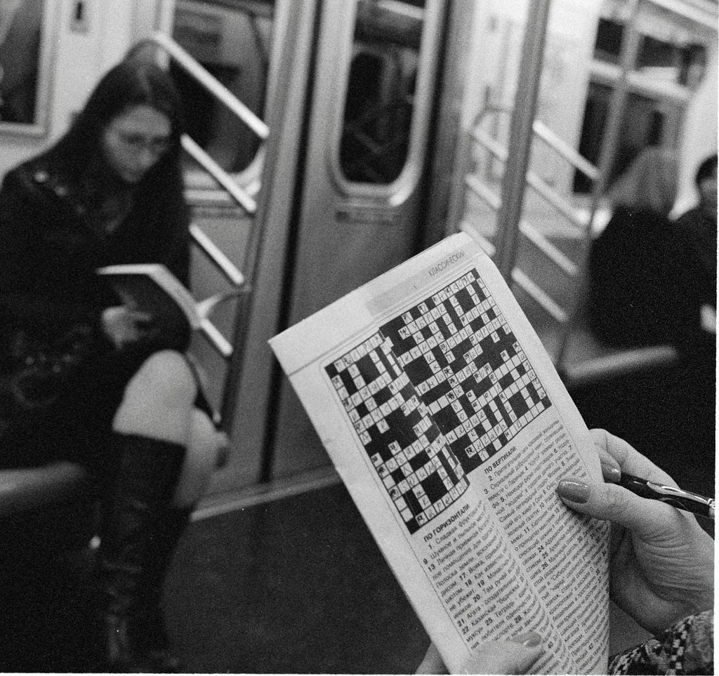 A person works on a crossword puzzle in the subway — NYC, 2008 by: Wil540 art