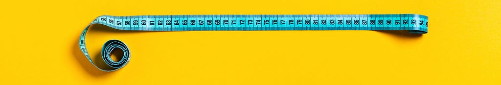 Blue tape measure on a yellow background.