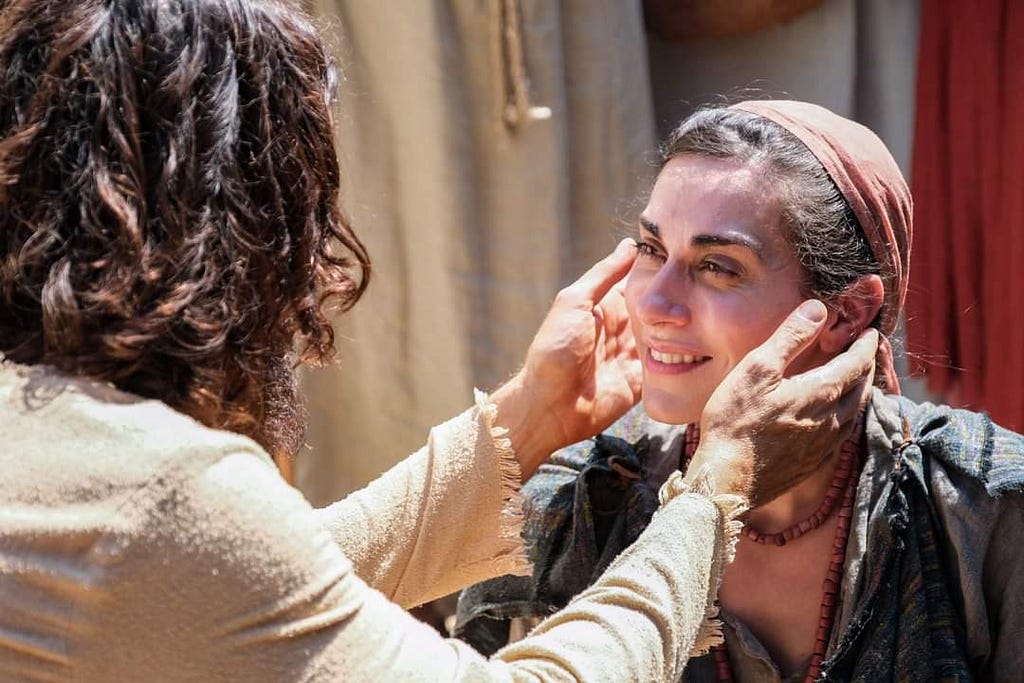 Actor who plays Jesus in the series “The Chosen” reaches out to cup the face and heal a woman who has been bleeding for 12 years.