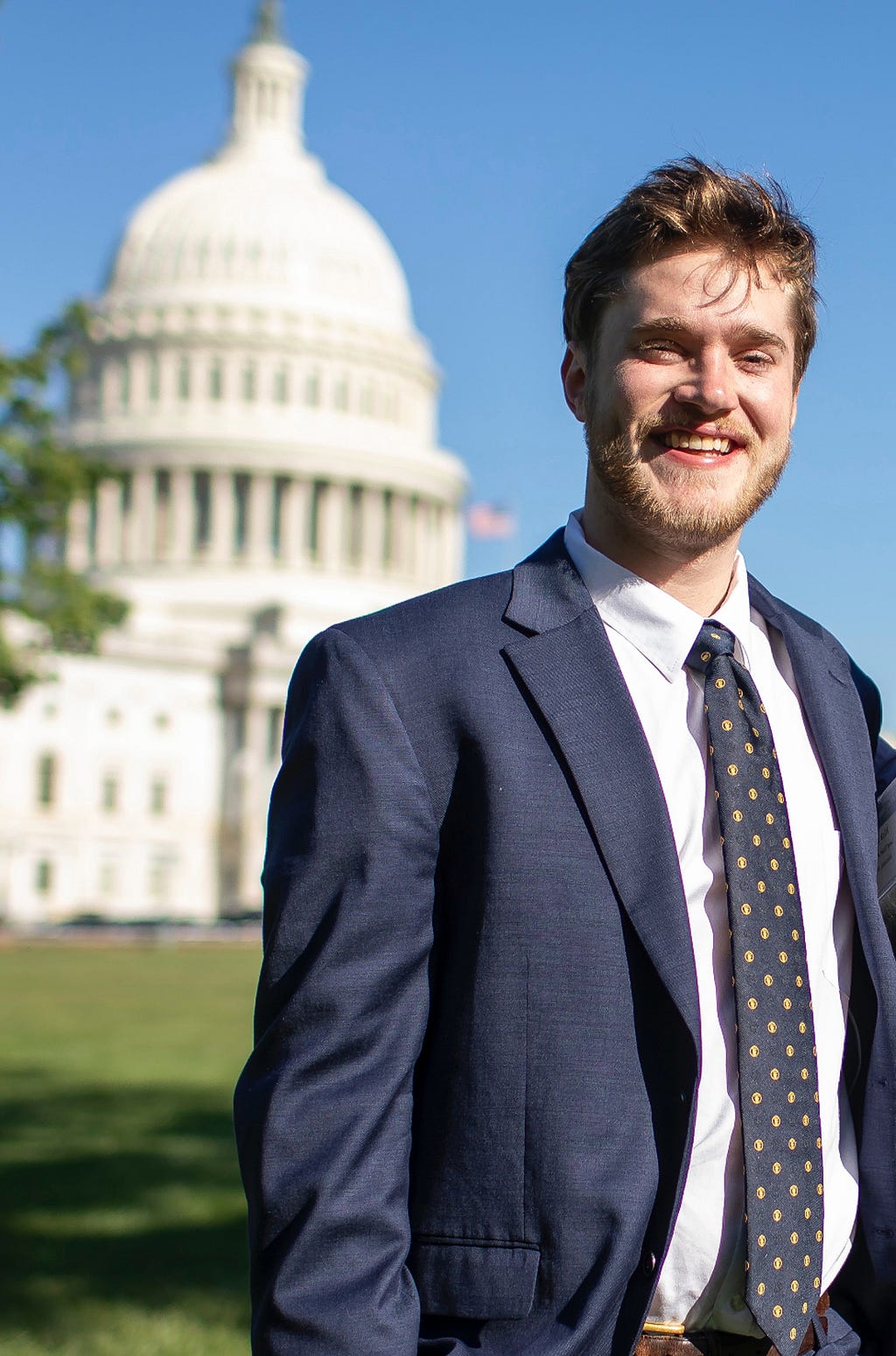 A picture of Nick Mills in front of the U.C. Capitol Building.