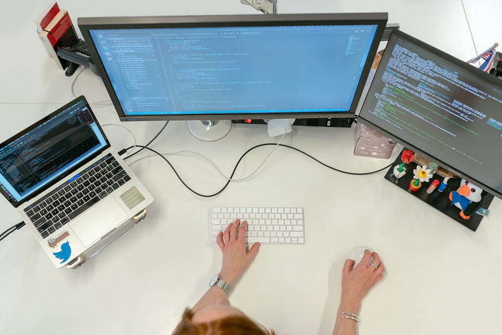 person coding at desk