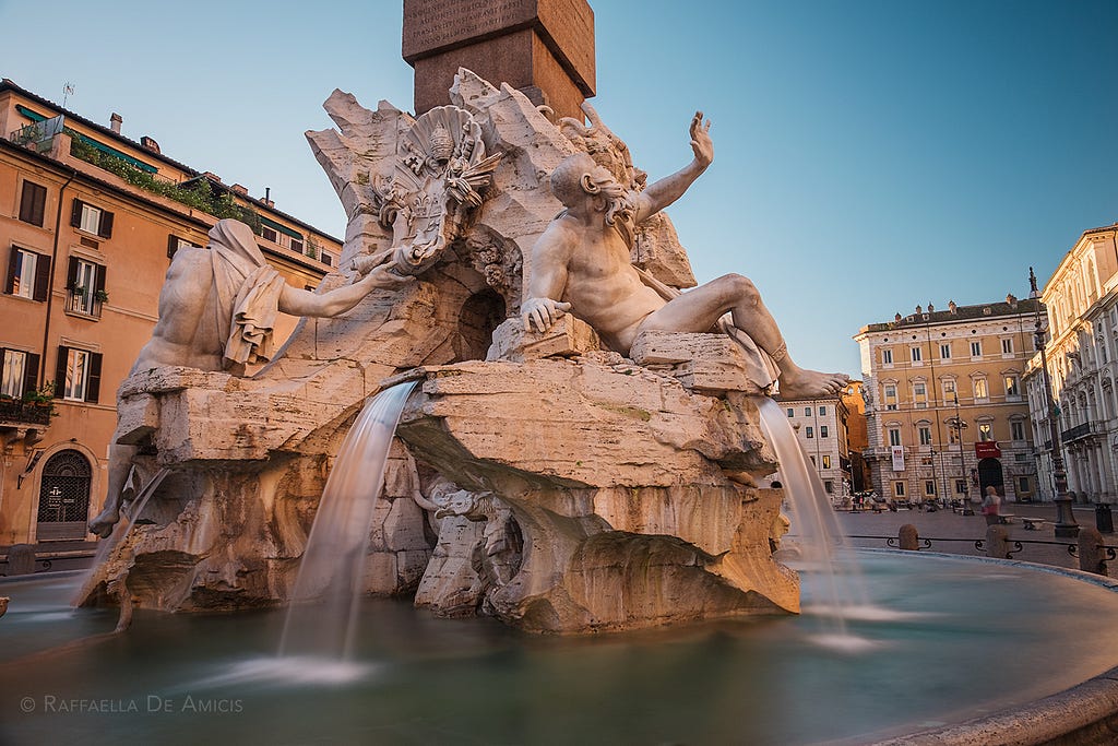 Fountain of the four rivers in Piazza Navona, Rome at sunrise