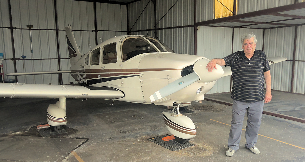 Photo of Allan Kash and his airplane.