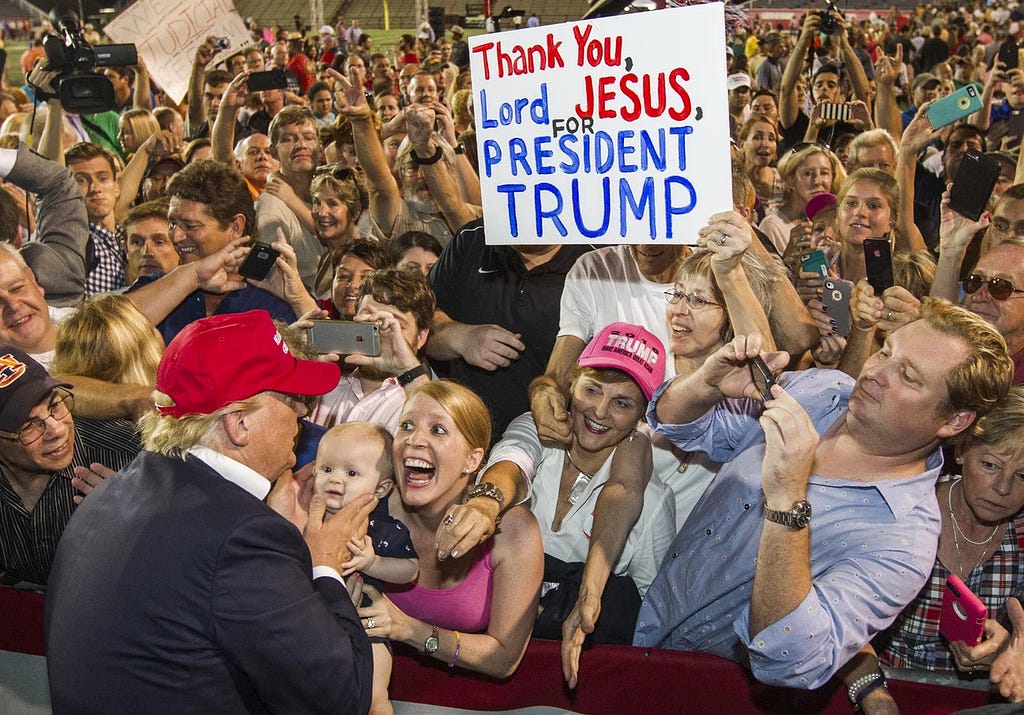 Christians hold sign for Donald, “Thanl you Lord Jesus for President Trump”